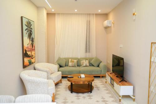 a living room with a couch and a tv at موتيل رامي سكاي Motel Rami Sky in Erbil