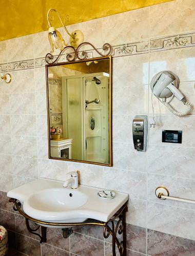 a bathroom with a sink and a mirror at La Mammola Bed&Breakfast in Fabriano