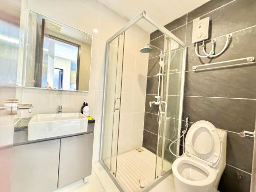 a bathroom with a shower and a toilet and a sink at Kingsbay Danga Bay Country Garden by Luxecocoo CK in Johor Bahru