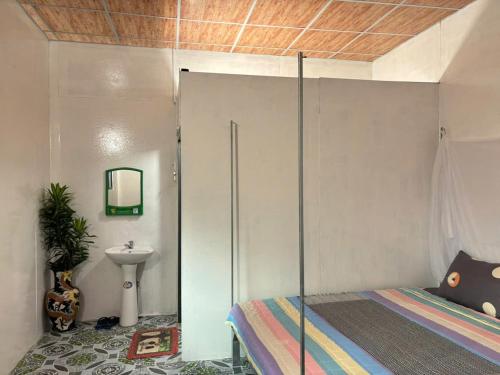 a bedroom with a bed and a sink at Mekong Delta Homestay Family Tiny Garden in Bến Lức
