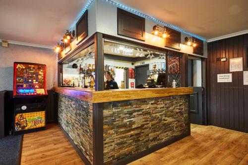 a bar in a room with a brick wall at Campsie Glen Holiday Park in Glasgow