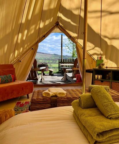 a bedroom with a bed and a view of a field at Catgill Farm in Bolton Abbey