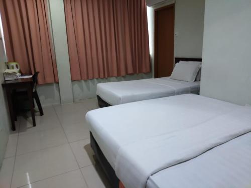 Cama o camas de una habitación en T Lodge, Kapit