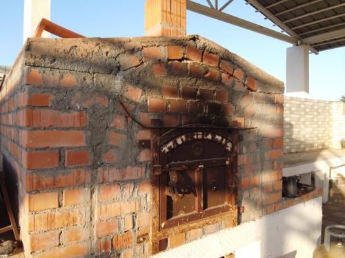 an old brick oven with an open door at Luban Camping House in Bidiyah