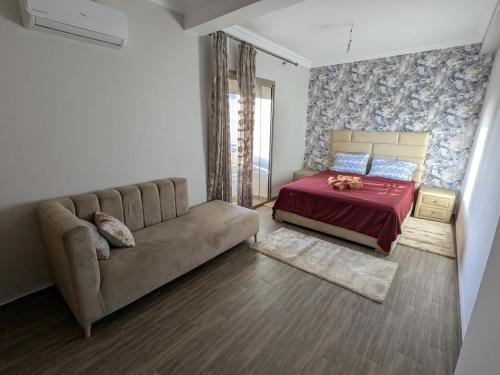 a living room with a couch and a bed at Janat House in Marrakech