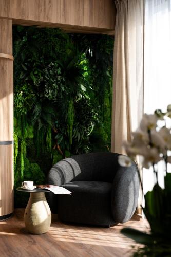 a black couch in a room with a green wall at Mercure Szczyrk Resort in Szczyrk