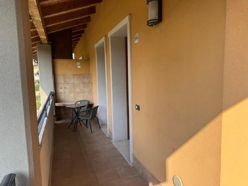a hallway of a house with a table and chairs at Kairos Garda Hotel in Castelnuovo del Garda