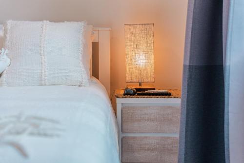 Un dormitorio con una cama blanca y una mesa. en Charlotte Street Towers, en Brisbane