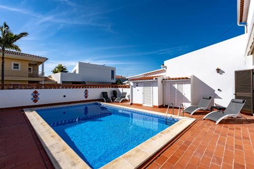 a swimming pool in the backyard of a house at Villa Leonie in Lagos