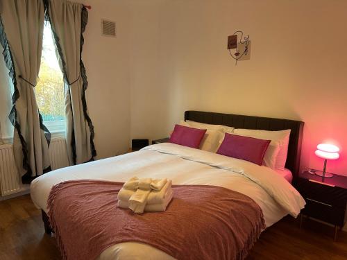 a bedroom with a large bed with red pillows at Private main door Two Bedrooms Apartment in Edinburgh