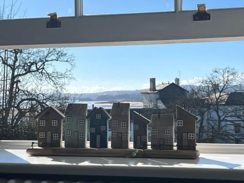 a group of houses sitting on a window sill at Exmouth 2 Bedroomed Seaview Apartment stones throw from the beach or town! in Exmouth