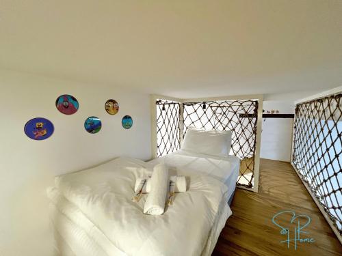 a bedroom with a bed with white sheets at Sunway GRID by SR Home in Kampong Pendas