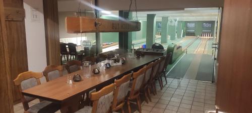 a dining room with a table and chairs and a bowling alley at Hotel Blocksberg in Wernigerode