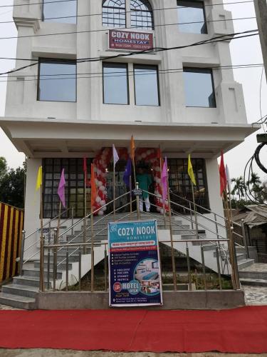 a building with a sign in front of it at Cozy Nook Home Stay in Dharmanagar