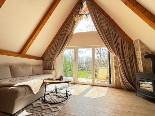 a living room with a couch and a large window at Vukova dolina apartments in Cetinje