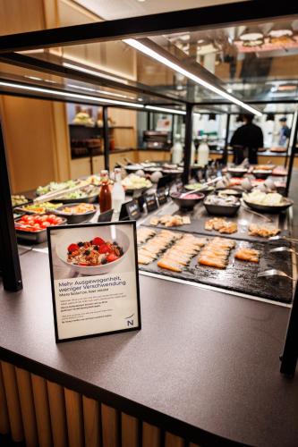 a buffet line with many different types of food at Novotel Hamburg Central Station in Hamburg