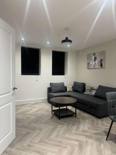 a living room with a couch and a table at The Verulam Retreat in St. Albans