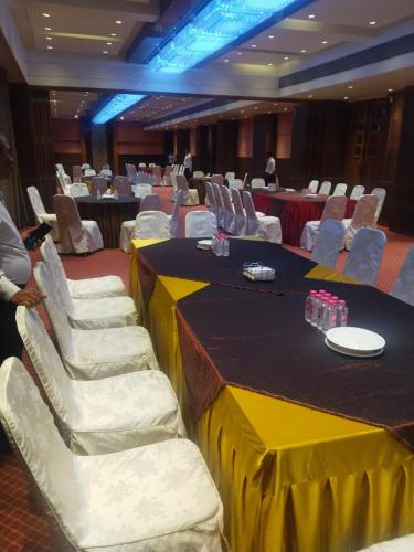 a conference room with a yellow table and chairs at The President-A Boutique Hotel in Ahmedabad