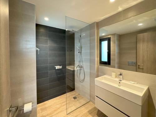 a bathroom with a sink and a glass shower at Artemis Blue in Artemida