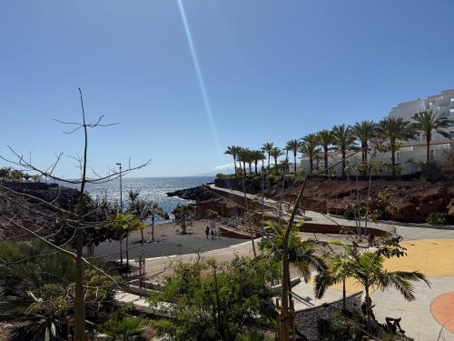 a view of a beach with palm trees and the ocean at CasaMaria in Playa Paraiso