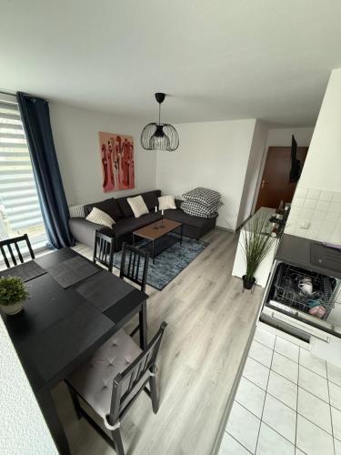 a living room with a table and a couch at Dreamhopp28 - Küche, bis zu 4 Personen in Magdeburg