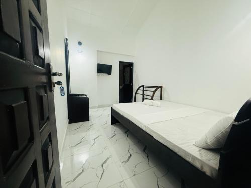 a bedroom with a bed and a room with a door at St Jude Holiday Resort in Talawakele