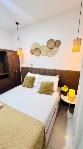a bedroom with a large bed and a table at Ap5- atrás da Passarela do Caranguejo Atalaia - térreo - 2 ar cond in Aracaju