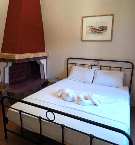 a bed with towels on it with a fireplace at TheOldHouse Seaview in Corfu