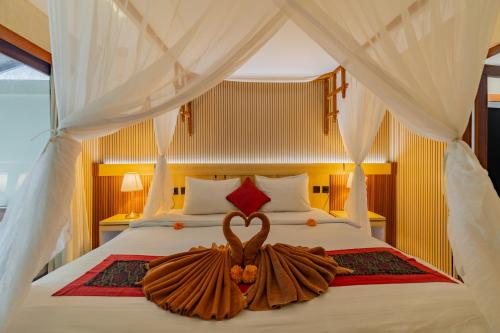 a bedroom with a bed with a heart decoration on it at Desak Putu Putra Hidden in Ubud