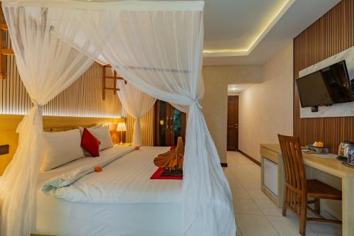 a bedroom with a bed with mosquito netting at Desak Putu Putra Hidden in Ubud