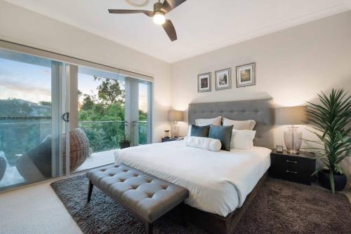 a bedroom with a large bed and a sliding glass door at Large Family Home with Pool & Spa in Brisbane