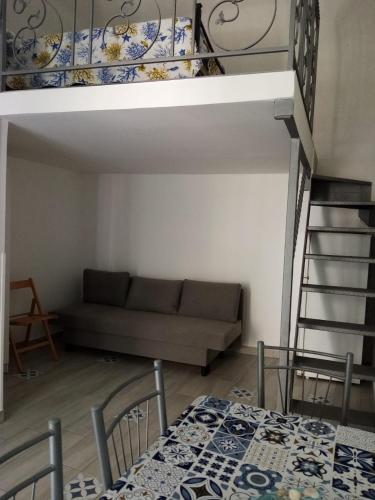 a living room with a couch and a bunk bed at Cantone Studio On The Beach in Cetara