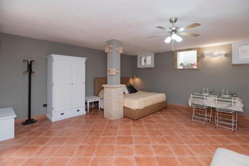 a bedroom with a bed and a table in a room at dépendance President villa Tuerredda in Chia