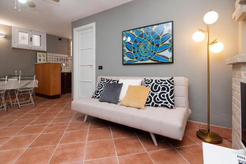a living room with a couch with pillows on it at dépendance President villa Tuerredda in Chia