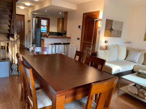 a dining room and living room with a table and chairs at Chalet Anayet Lodge Luxury 5 Stars in Formigal in Formigal