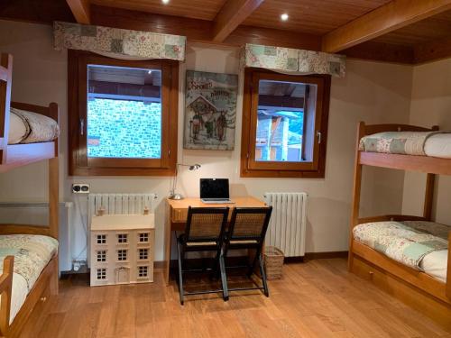 a room with a desk with a laptop on it at Chalet Anayet Lodge Luxury 5 Stars in Formigal in Formigal