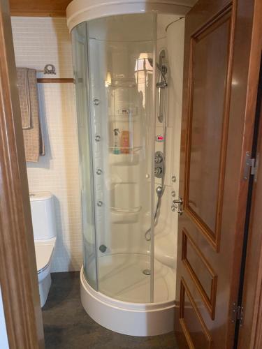 a glass shower in a bathroom with a toilet at Chalet Anayet Lodge Luxury 5 Stars in Formigal in Formigal