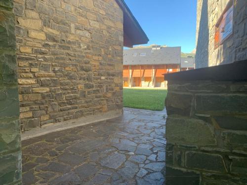 a stone walkway next to a brick building at Chalet Anayet Lodge Luxury 5 Stars in Formigal in Formigal