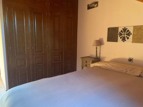 a bedroom with a bed and a table with a lamp at Chalet Anayet Lodge Luxury 5 Stars in Formigal in Formigal