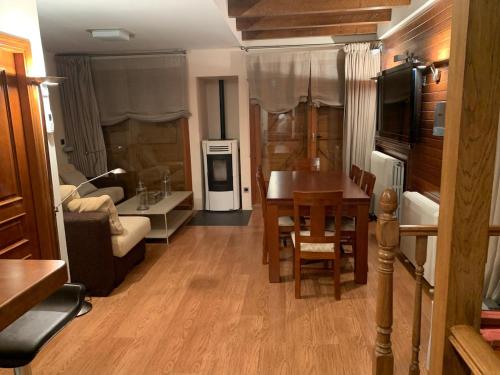 a living room with a kitchen and a dining room at Chalet Anayet Lodge Luxury 5 Stars in Formigal in Formigal