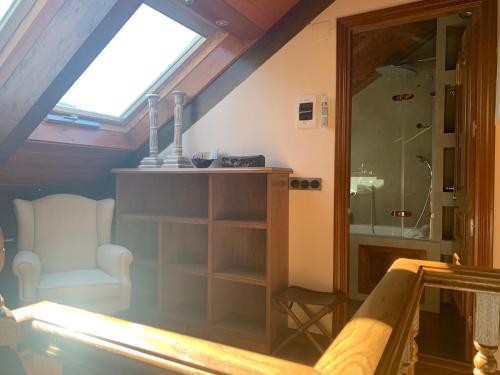 a attic room with a shower and a glass door at Chalet Anayet Lodge Luxury 5 Stars in Formigal in Formigal