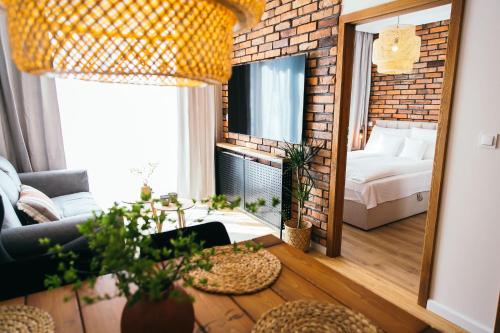 a living room with a bed and a mirror at Apartament Ulubiony Mariental Residence in Szklarska Poręba