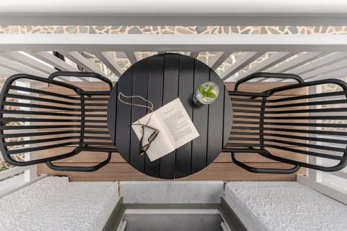 a black table with a book on it on a balcony at Anatoli Hotel in Naxos Chora