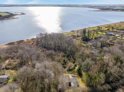 an aerial view of the shore of a lake at Holiday Home With Pool And Spa Close To The Limfjord in Roslev