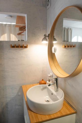 a bathroom with a sink and a mirror at Suite 5 in Cala del Moral