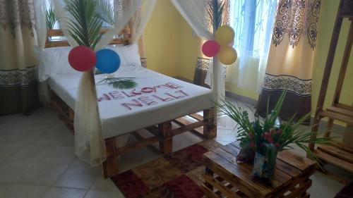 a bedroom with a happy new year sign and balloons at Mount Zion Guest House, Mtwapa Mtomondoni in Mombasa