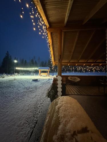 a covered area with lights and snow on the ground at Шале Вілія in Vorokhta