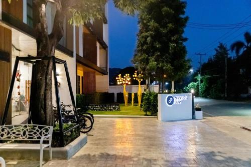 a bike parked next to a building at night at Ananzitra Hotel in Kanchanaburi