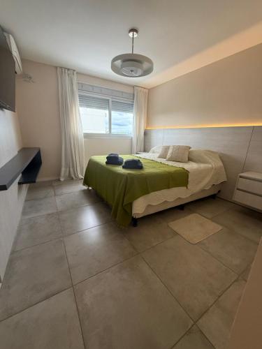 a bedroom with a bed and a large window at Departamento 3 Habitaciones Zona Cincuentenario in Formosa