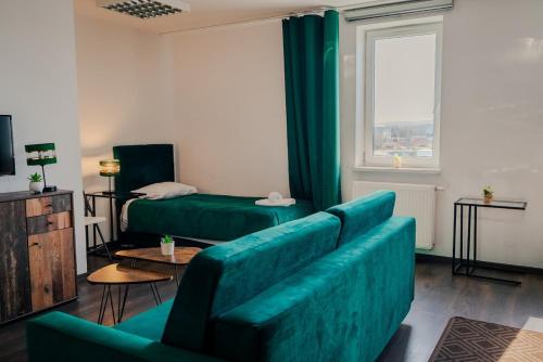 a living room with green furniture and a couch at Hotel Świt in Kraków